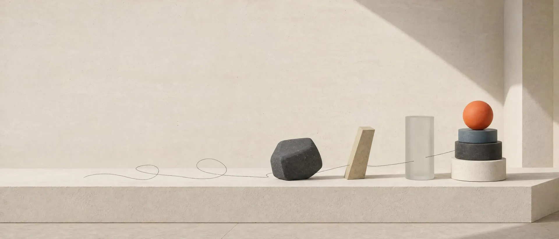 A long stone plinth with five small forms laid out in a row, a pencil line linking them