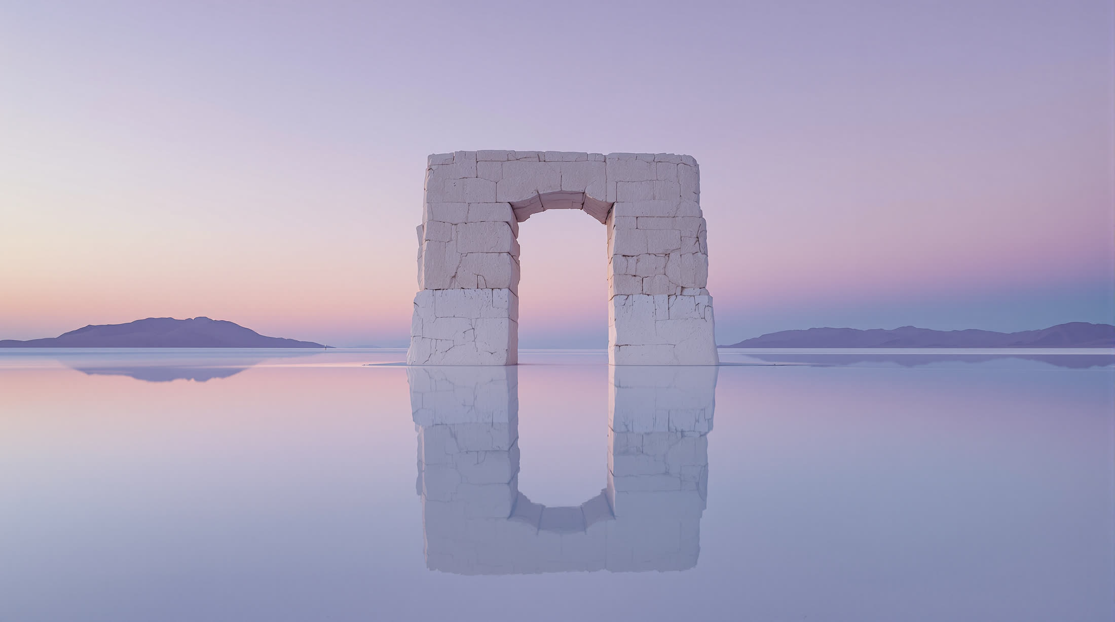 The arch on an endless white salt lake at dusk, perfectly reflected under a lavender sky.