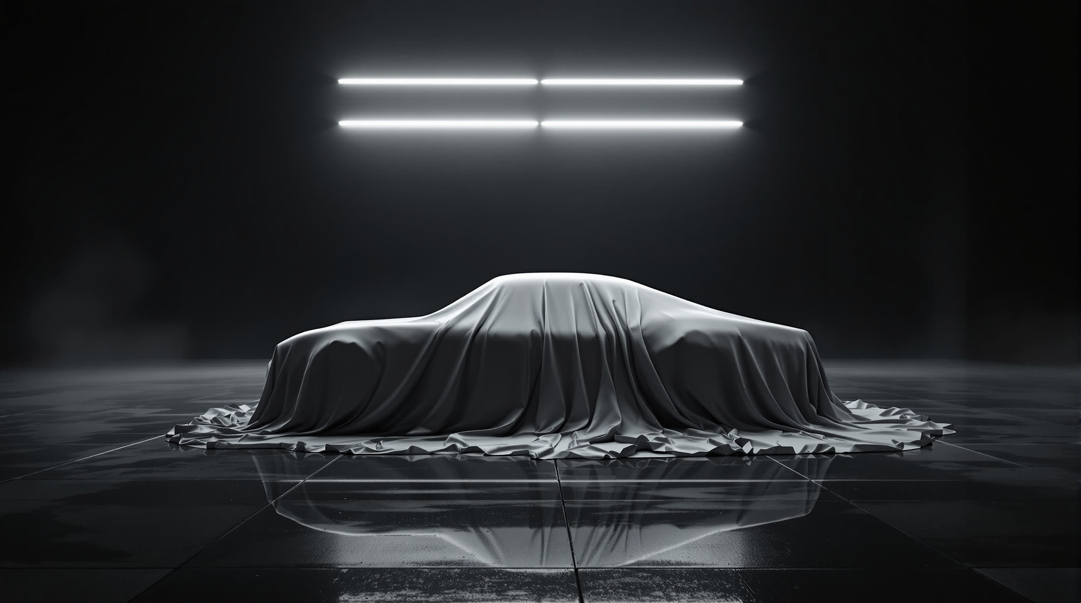 The car beneath a silk dust sheet, lit by two crossing light bars.